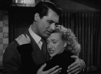 Movie still from “Arsenic and Old Lace” (1944), directed by Frank Capra – A man and a woman embracing each other in a black and white photo; Close Up shot, Low angle