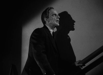 Movie still from “Arsenic and Old Lace” (1944), directed by Frank Capra – A black and white photo of a man in a suit; Close Up shot, Low angle