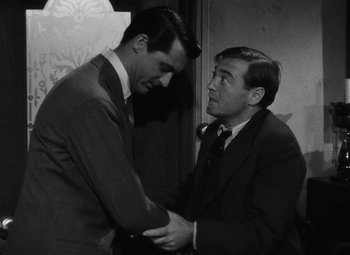 Movie still from “Arsenic and Old Lace” (1944), directed by Frank Capra – Two men in suits shaking hands in front of a wall; Medium shot, Over the shoulder angle