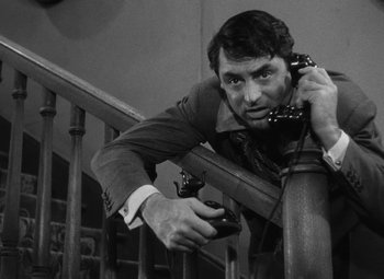 Movie still from “Arsenic and Old Lace” (1944), directed by Frank Capra – A black and white photo of a man holding a phone; Close Up shot, Overhead angle