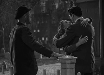 Movie still from “Arsenic and Old Lace” (1944), directed by Frank Capra – A man and a woman hugging in front of a fire hydrant; Medium shot, Over the shoulder angle