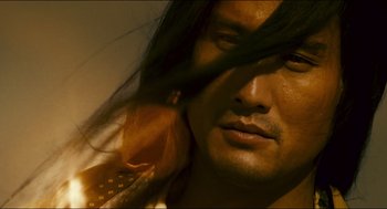 Movie still from “Ashes of Time” (1994), directed by Kar-Wai Wong – A man's face with long black hair; Close Up shot, Low angle