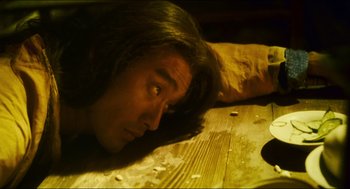 Movie still from “Ashes of Time” (1994), directed by Kar-Wai Wong – A man laying on the ground with his head down; Close Up shot, High angle