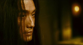 Movie still from “Ashes of Time” (1994), directed by Kar-Wai Wong – A person with long black hair; Close Up shot, Low angle