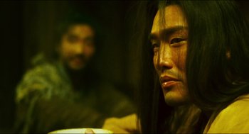 Movie still from “Ashes of Time” (1994), directed by Kar-Wai Wong – A man with long hair sitting next to another man; Close Up shot, Over the shoulder angle