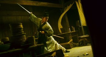 Movie still from “Ashes of Time” (1994), directed by Kar-Wai Wong – A man in traditional japanese garb holding a sword; Wide shot, Low angle