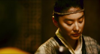 Movie still from “Ashes of Time” (1994), directed by Kar-Wai Wong – A young man wearing a head band is looking to his left; Close Up shot, Over the shoulder angle