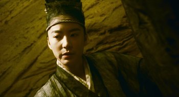 Movie still from “Ashes of Time” (1994), directed by Kar-Wai Wong – A young man wearing a robe and a crown; Close Up shot, Low angle