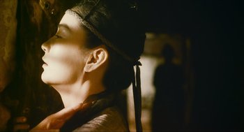 Movie still from “Ashes of Time” (1994), directed by Kar-Wai Wong – A woman's face with a bow on her head; Close Up shot, Over the shoulder angle