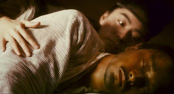 Movie still from “Ashes of Time” (1994), directed by Kar-Wai Wong – Two people laying in a bed with one of them sleeping; Close Up shot, Overhead angle
