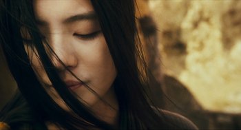 Movie still from “Ashes of Time” (1994), directed by Kar-Wai Wong – A woman's face with her eyes closed; Close Up shot, Low angle