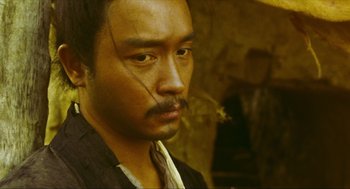 Movie still from “Ashes of Time” (1994), directed by Kar-Wai Wong – A person with a mustache; Close Up shot, Low angle