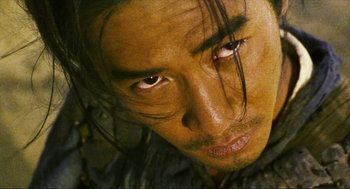 Movie still from “Ashes of Time” (1994), directed by Kar-Wai Wong – A man's face with long hair; Close Up shot, High angle