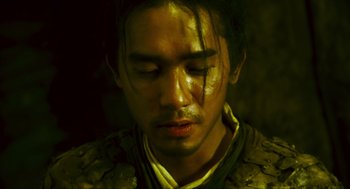 Movie still from “Ashes of Time” (1994), directed by Kar-Wai Wong – A person with a face paint; Close Up shot, High angle