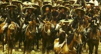 Movie still from “Ashes of Time” (1994), directed by Kar-Wai Wong – A group of men on horses in a field; Wide shot, High angle