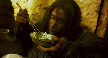 Movie still from “Ashes of Time” (1994), directed by Kar-Wai Wong – A woman holding a bowl of food in her hands; Close Up shot, High angle