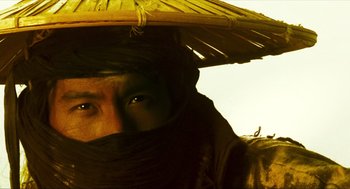 Movie still from “Ashes of Time” (1994), directed by Kar-Wai Wong – A man with a hat and a scarf on his head; Close Up shot, Low angle