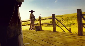 Movie still from “Ashes of Time” (1994), directed by Kar-Wai Wong – A person standing on top of a wooden platform; Wide shot, Low angle
