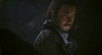 Movie still from “Ashes of Time” (1994), directed by Kar-Wai Wong – A person with long black hair; Close Up shot, Low angle