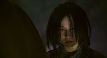 Movie still from “Ashes of Time” (1994), directed by Kar-Wai Wong – A young girl with long black dreadlocks looking into a mirror; Close Up shot, Low angle