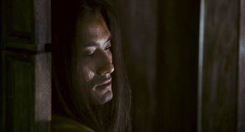 Movie still from “Ashes of Time” (1994), directed by Kar-Wai Wong – A person with long black hair; Close Up shot, Low angle