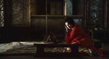 Movie still from “Ashes of Time” (1994), directed by Kar-Wai Wong – A woman sitting on the floor in front of a mirror; Wide shot, High angle