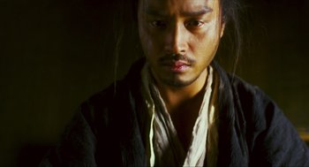 Movie still from “Ashes of Time” (1994), directed by Kar-Wai Wong – A person with long black hair; Close Up shot, Low angle