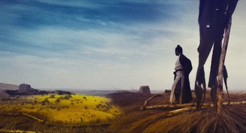 Movie still from “Ashes of Time” (1994), directed by Kar-Wai Wong – A man standing on top of a dirt hill; Extreme Wide shot, Low angle