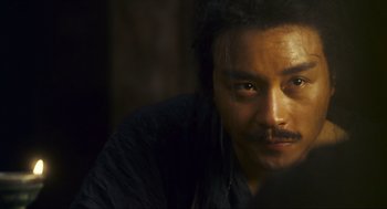 Movie still from “Ashes of Time” (1994), directed by Kar-Wai Wong – A person with a beard; Close Up shot, Over the shoulder angle