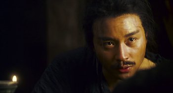 Movie still from “Ashes of Time” (1994), directed by Kar-Wai Wong – A person wearing a black shirt; Close Up shot, Over the shoulder angle