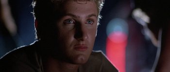 Movie still from “At Close Range” (1986), directed by James Foley – A man's face in the dark; Close Up shot, Low angle