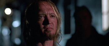 Movie still from “At Close Range” (1986), directed by James Foley – A person with long hair and a beard; Close Up shot, Low angle