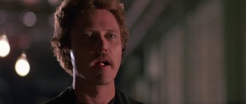 Movie still from “At Close Range” (1986), directed by James Foley – A person with a beard and a mustache; Close Up shot, Low angle