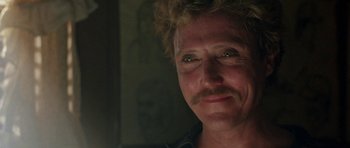 Movie still from “At Close Range” (1986), directed by James Foley – A person with a beard; Close Up shot, Over the shoulder angle