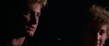 Movie still from “At Close Range” (1986), directed by James Foley – A person's face in the dark; Close Up shot, Low angle