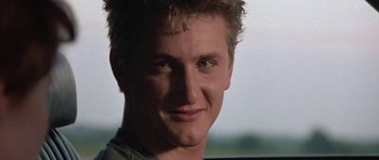 Movie still from “At Close Range” (1986), directed by James Foley – A young man's face in a car; Close Up shot, Low angle