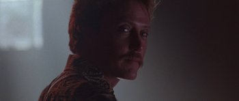 Movie still from “At Close Range” (1986), directed by James Foley – A person with a mustache; Close Up shot, Low angle