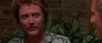 Movie still from “At Close Range” (1986), directed by James Foley – A person with a mustache; Close Up shot, Over the shoulder angle