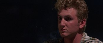 Movie still from “At Close Range” (1986), directed by James Foley – A person smoking a cigarette; Close Up shot, Low angle