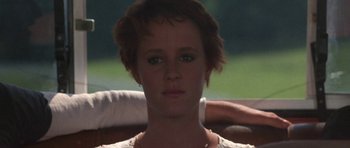 Movie still from “At Close Range” (1986), directed by James Foley – A person with short brown hair; Close Up shot, Over the shoulder angle