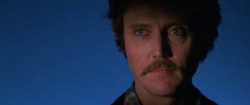 Movie still from “At Close Range” (1986), directed by James Foley – A person with a mustache; Close Up shot, Low angle