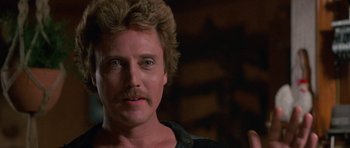 Movie still from “At Close Range” (1986), directed by James Foley – A person with a mustache; Close Up shot, Low angle