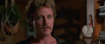 Movie still from “At Close Range” (1986), directed by James Foley – A person with a mustache; Close Up shot, Low angle