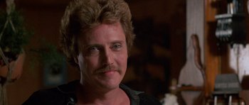 Movie still from “At Close Range” (1986), directed by James Foley – A person with a mustache; Close Up shot, Low angle