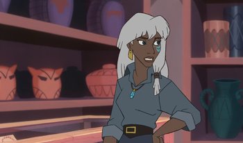 Movie still from “Atlantis: Milo's Return” (2003), directed by Tad Stones – An animated woman in a blue shirt is looking at the camera; Close Up shot, Over the shoulder angle