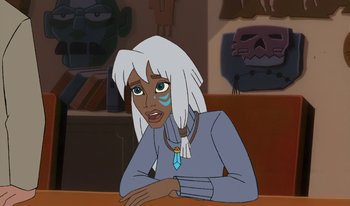 Movie still from “Atlantis: Milo's Return” (2003), directed by Tad Stones – An animated woman sitting in front of a table; Close Up shot, Over the shoulder angle