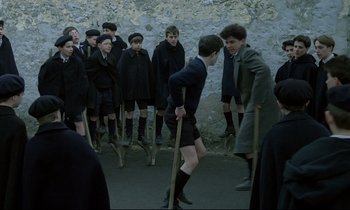Movie still from “Au revoir les enfants” (1987), directed by Louis Malle – A group of young men standing next to each other; Wide shot, High angle