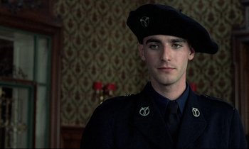 Movie still from “Au revoir les enfants” (1987), directed by Louis Malle – A man in a military uniform wearing a hat; Close Up shot, Over the shoulder angle