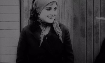 Movie still from “Au revoir les enfants” (1987), directed by Louis Malle – An old photo of a woman wearing a headscarf; Close Up shot, Low angle