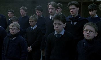 Movie still from “Au revoir les enfants” (1987), directed by Louis Malle – A group of young men standing next to each other; Medium shot, High angle